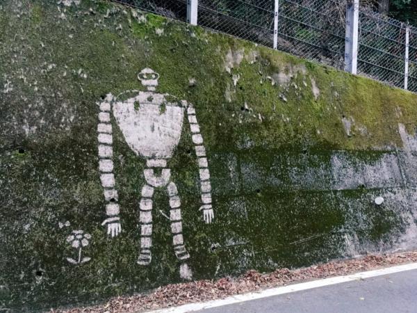 The Ghibli characters appear mysteriously on the moss wall in Japan